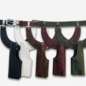May include: A collection of five leather utility belts, each featuring a curved holster attachment. The belts are available in black, white, brown, dark red, and olive green, all equipped with matching metal buckles and hardware fasteners.