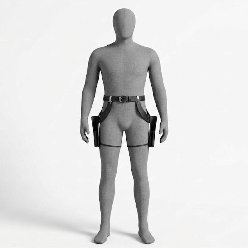 May include: A black leather dual holster rig worn on a grey mannequin. The set includes a waist belt with a silver-toned metal buckle, two side holsters hanging from adjustable straps, and two thin leg straps that secure each holster to the thighs.