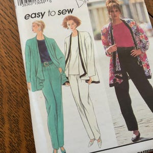 May include: A vintage sewing pattern featuring illustrations of women's suits. The pattern includes a teal suit, a white suit with black trim, and a floral print jacket with black pants. The text "easy to sew" is visible.