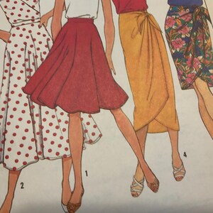 May include: A sewing pattern illustration featuring four skirt designs: a white wrap skirt with red polka dots, a solid red A-line skirt, a solid yellow wrap skirt with a tie waist, and a floral print wrap skirt with pink and green patterns.