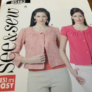 May include: A sewing pattern with the text "See & Sew" and "Yes! It's Easy". The pattern features illustrations of two jackets, one in pink tweed and the other in bright pink. The pattern number is B5482.