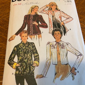 May include: A sewing pattern for four different jackets. The pattern is for size 10 and includes instructions for a burgundy jacket with a lace trim, a white and black striped jacket with a bow, a black and white patterned jacket, and a pink and white patterned jacket.