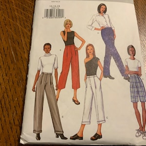 May include: A sewing pattern featuring five different styles of pants. The pattern includes a pair of wide-leg pants, a pair of cropped pants, a pair of cuffed pants, a pair of plaid shorts, and a pair of blue jeans. The pattern is labeled "1416-18".