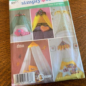 May include: A sewing pattern titled "simply easy canopies" featuring several canopy designs. The designs include canopies with floral, heart, and star-shaped accents. The pattern cover has a barcode and the brand name "onso".