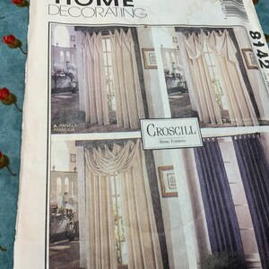 May include: A sewing pattern for curtains with two different styles. The pattern is for a pair of curtains with a tab top and a pair of curtains with a swag valance. The pattern is from Croscill Home Fashions.