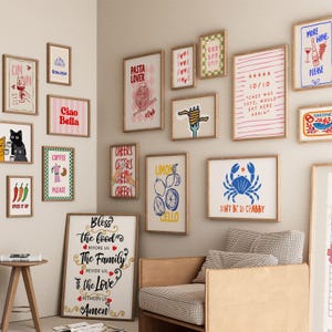 May include: A collection of framed art prints with various themes, including food, drinks, and inspirational quotes. The prints feature illustrations of pasta, coffee, lemons, and cats, with text like "Ciao Bella" and "Don't Be So Crabby."