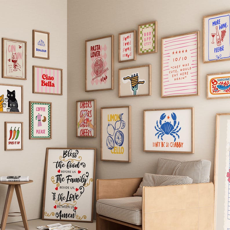 May include: A collection of framed art prints with various themes, including food, drinks, and inspirational quotes. The prints feature illustrations of pasta, coffee, lemons, and cats, with text like "Ciao Bella" and "Don't Be So Crabby."