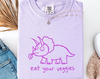 T-shirt végétalien humoristique « Mangez vos légumes » avec un tricératops herbivore