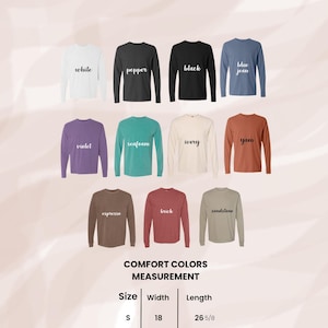 May include: A display of long-sleeve t-shirts in various colors, including white, black, and blue jean. The image includes a size chart with measurements in inches for width and length. The text on the image reads "LONG SLEEVE T-SHIRT - COMFORT COLORS 6014."