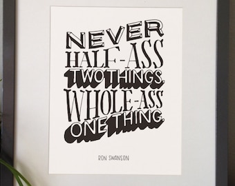 May include: A framed print with a black and white quote that reads "Never half-ass two things. Whole-ass one thing." The quote is attributed to Ron Swanson.