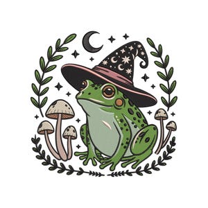 May include: An embroidered design featuring a green frog wearing a black witch hat with pink trim and celestial details. The frog is surrounded by mushrooms, stars, a crescent moon, and leafy branches, all on a white background.