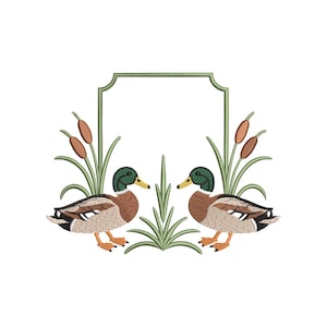 May include: An embroidered design featuring two ducks facing each other, with green heads and brown bodies, surrounded by cattails and reeds. A green frame sits above the ducks, all on a white background.