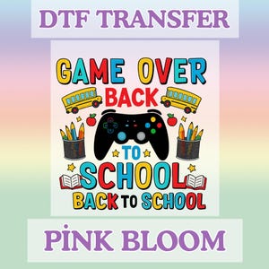 May include: A DTF transfer design with the text "GAME OVER BACK TO SCHOOL" in yellow, red, and blue. The design includes a black game controller, school buses, pencils, apples, and open books. The text "PINK BLOOM" is at the bottom.