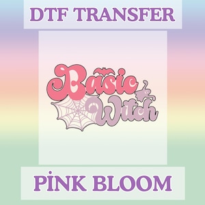 May include: A DTF transfer design with the words "Basic Witch" in pink and purple bubble letters, with a spiderweb and bat graphic. The words "DTF TRANSFER" and "PINK BLOOM" are also displayed.