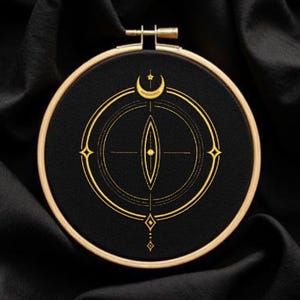 May include: A black embroidery hoop with a gold celestial design. The design features a crescent moon, star, and geometric shapes. The embroidery hoop is made of wood and has a gold metal clasp.
