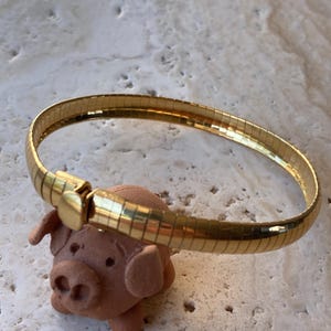 Gold tone Omega chain braceletSim