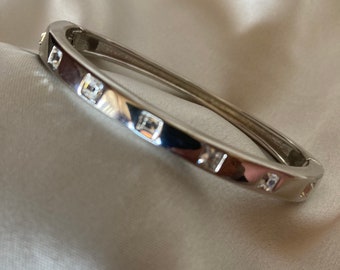 Silver tone hinged bangle with square cubic zirconia stones
