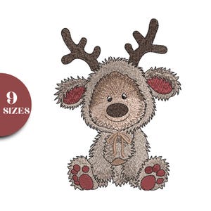 May include: An embroidered design of a seated reindeer with a brown nose, antlers, and paws. The reindeer is wearing a hood with red-lined ears and a bow. The text "9 SIZES" is in a maroon circle.