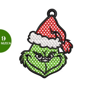 May include: Embroidered Christmas ornament featuring a green face with an angry expression, wearing a red and white Santa hat. The design has a black outline and a loop for hanging. The text "9 SIZES" is in a green circle.