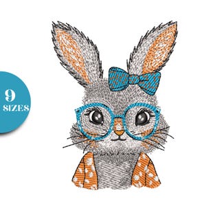 May include: Embroidered design of a gray bunny wearing blue glasses and a bow tie. The bunny has orange accents on its ears and clothing. A teal circle with the number "9" and the word "SIZES" is in the corner.
