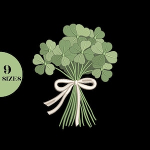 May include: An embroidered bouquet of green shamrocks tied with a white ribbon. The image is set against a black background. A green circle with the text "9 SIZES" is in the lower left corner.