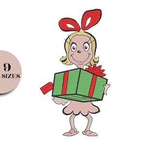 May include: An embroidered design of a cartoon character with blonde hair and a red bow, holding a green gift box with red ribbons. The character is wearing a pink dress and has a smiling expression. The image includes the text "9 SIZES" in a circle.