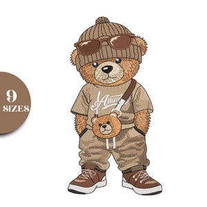 May include: Embroidered design of a brown teddy bear wearing a beanie, sunglasses, and a crossbody bag. The bear is dressed in a tan t-shirt, matching pants, and sneakers. The image includes the text "9 SIZES" in a brown circle.