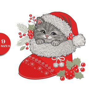 May include: An embroidered design featuring a gray kitten wearing a Santa hat, peeking out of a red Christmas stocking. The stocking is decorated with snowflakes and stars. Holly berries and sprigs surround the kitten and stocking.