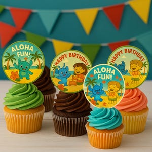 May include: Cupcakes with colorful frosting and decorative toppers featuring cartoon characters and the phrases "Aloha Fun!" and "Happy Birthday." The cupcakes have yellow, green, chocolate, and orange frosting.