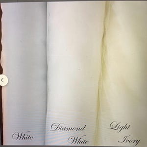 Pu&ograve; includere: Tre campioni di tessuto in bianco, bianco diamante e avorio chiaro. I tessuti sono trasparenti e sembrano tulle o rete. I nomi dei colori sono scritti in corsivo sotto ogni campione.
