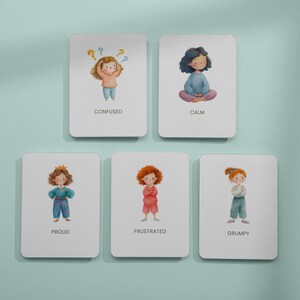 May include: Five white cards with illustrations of children depicting different emotions: Confused, Calm, Proud, Frustrated, and Grumpy. Each card features a watercolor-style drawing of a child and the emotion's name.