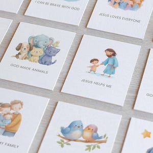 May include: A collection of illustrated cards with religious themes. The cards feature watercolor images of animals, Jesus, families, and nature scenes. Text on the cards includes phrases like "God Made Animals" and "Jesus Helps Me."