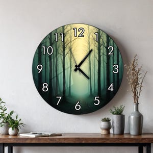 May include: A round wall clock featuring a printed image of a forest path with tall trees in shades of green and yellow. The clock face displays large white numbers from 1 to 12 and has two black hands indicating the time against the forest scene.