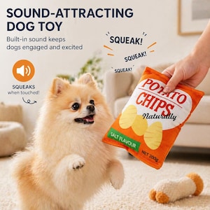 May include: A fluffy, light brown Pomeranian dog stands near a plush toy shaped like a bag of potato chips. The toy is orange with the words "POTATO CHIPS Naturally" and "SALT FLAVOUR" printed on it. The toy is being held by a person.