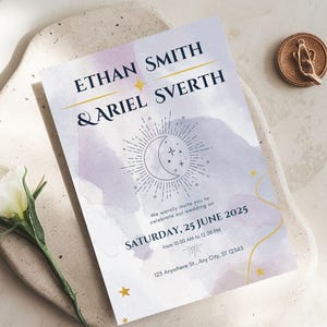 May include: A wedding invitation with the names Ethan Smith & Ariel Sverth, featuring a celestial design with a crescent moon and stars. The invitation is on a white background with a watercolor wash of purple and blue. A white flower and a gold wax seal are also present.