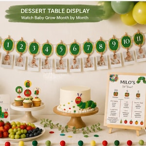 May include: A dessert table display featuring a monthly photo banner with The Very Hungry Caterpillar theme, a white cake with a caterpillar topper, cupcakes, a book, a milestone sign for Milo's 1st Year, and bowls of fresh fruit.
