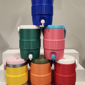 May include: A collection of brightly coloured water coolers in blue, green, pink, yellow, orange, and red. Each cooler has a white lid, a tap, and a handle. The coolers are cylindrical with ribbed detailing.