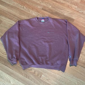 90’s champion crewneck in a redish burgundy color. size XL