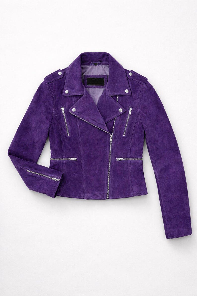 May include: A striking purple suede biker jacket. It has a notched collar, an asymmetrical zip, multiple zipped pockets, and silver-tone hardware. The jacket is tailored with long sleeves. The measurements are in centimetres.