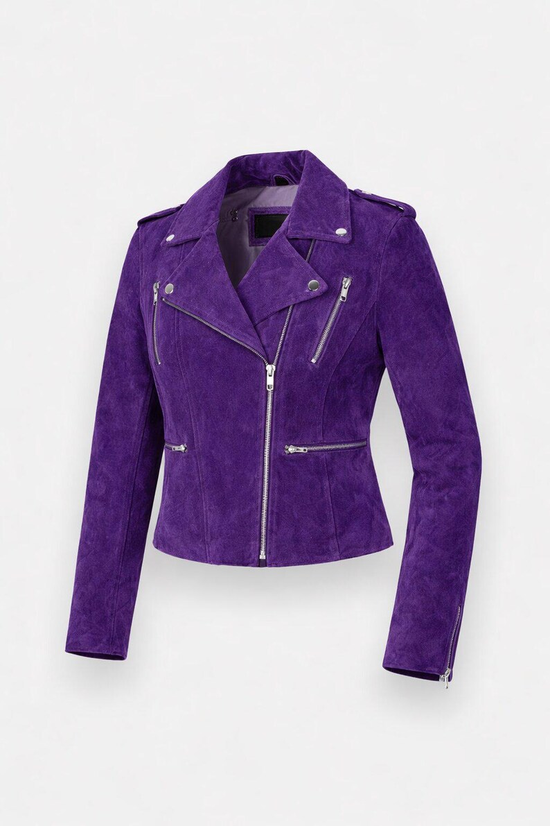 May include: A striking purple suede biker jacket. It has a notched collar, an asymmetrical zip, and multiple zipped pockets. The jacket is finished with silver hardware and has long sleeves. The fit is tailored.