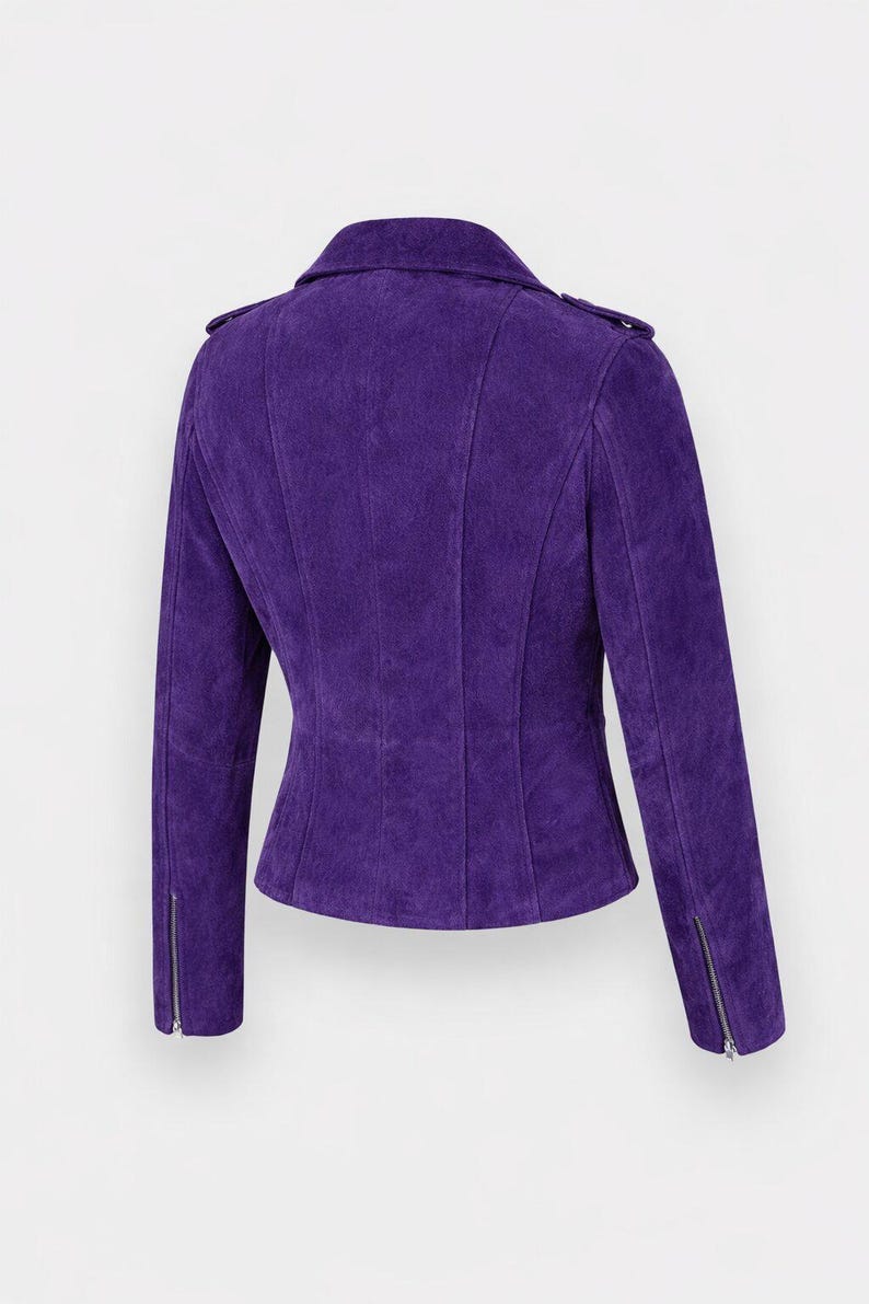 May include: A striking purple suede jacket in a biker style. It has a notched collar, an asymmetrical zip, and zipped cuffs. The jacket is tailored with vertical seams for a flattering fit. The colour is a rich, deep purple.