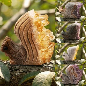 May include: A collection of carved squirrel figurines. The squirrels are brown with a textured appearance, and their tails are made of yellow and orange crystals. The figurines are displayed on a tree branch.