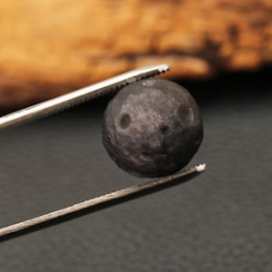 May include: A set of three ceramic mugs with a speckled, matte finish. The mugs are in shades of cream, light gray, and dark gray. Each mug has a simple, minimalist design and a rounded handle. Perfect for coffee or tea.