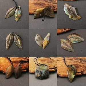 Peut inclure: Collection de pendentifs et de sculptures en forme de feuilles en labradorite. Les pendentifs sont montés sur des cordons noirs. Les pierres présentent des couleurs irisées bleues, vertes et dorées. Les sculptures ont des motifs de veines de feuilles détaillés.