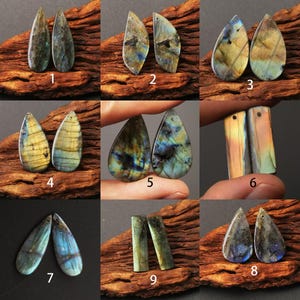 May include: A collection of nine pairs of labradorite gemstone pendants in various shapes. The pendants display iridescent colors of blue, green, yellow, and gray. Each stone has a drilled hole for jewelry making.