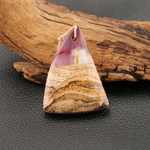 May include: A triangular pendant with a natural stone appearance. The top portion is a deep burgundy color, transitioning to a beige and brown patterned base. A small hole at the top holds a beige string for hanging.