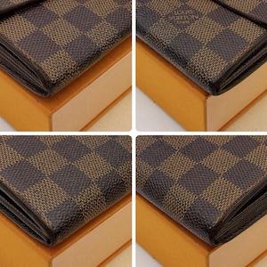 May include: Close-up of a brown and tan checkered wallet. The wallet is on top of a light brown box. The wallet has a dark brown border and a small logo in the upper right corner.