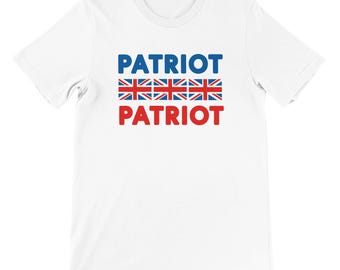May include: White t-shirt featuring the word "PATRIOT" in blue and red, with three rows of the Union Jack flag design. The shirt has a round neck and short sleeves.