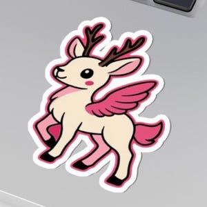 May include: A sticker featuring a cartoon deer with pink wings, antlers, and accents. The deer is cream-colored with black outlines and a white border. The sticker has a whimsical and cute design.