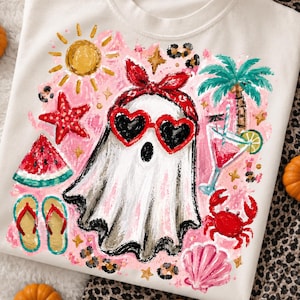 May include: White sweatshirt with a colorful graphic of a ghost wearing heart-shaped sunglasses and a red bandana. The design includes a watermelon slice, starfish, flip-flops, a cocktail, and a palm tree, all set against a pink background.